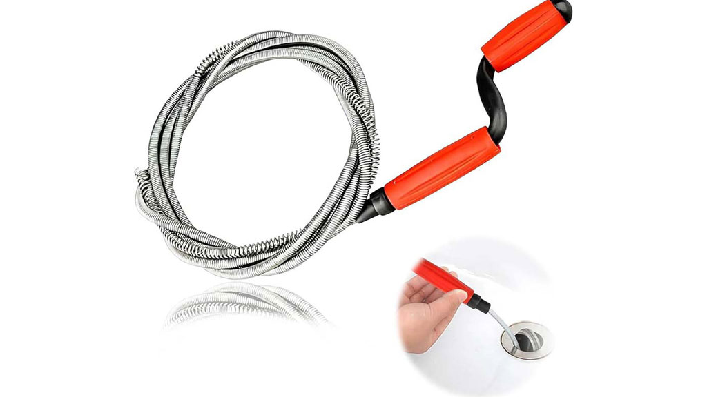 Plombier utilisant un furet électrique pour déboucher une canalisation de salle de bain